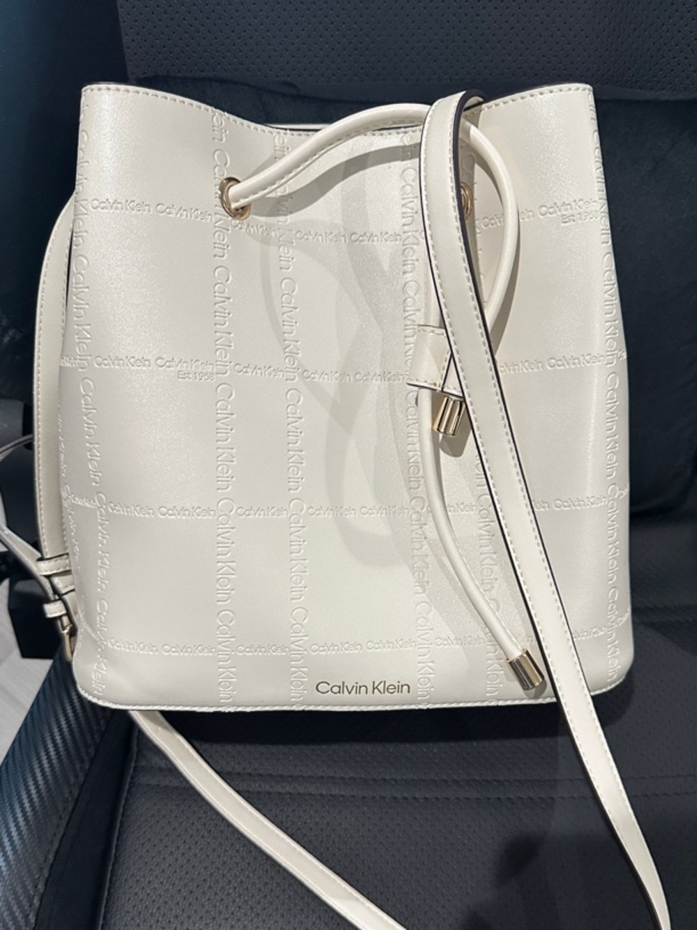 Calvin Klein Cream Logo-Embossed Drawstring Crossbody Bag